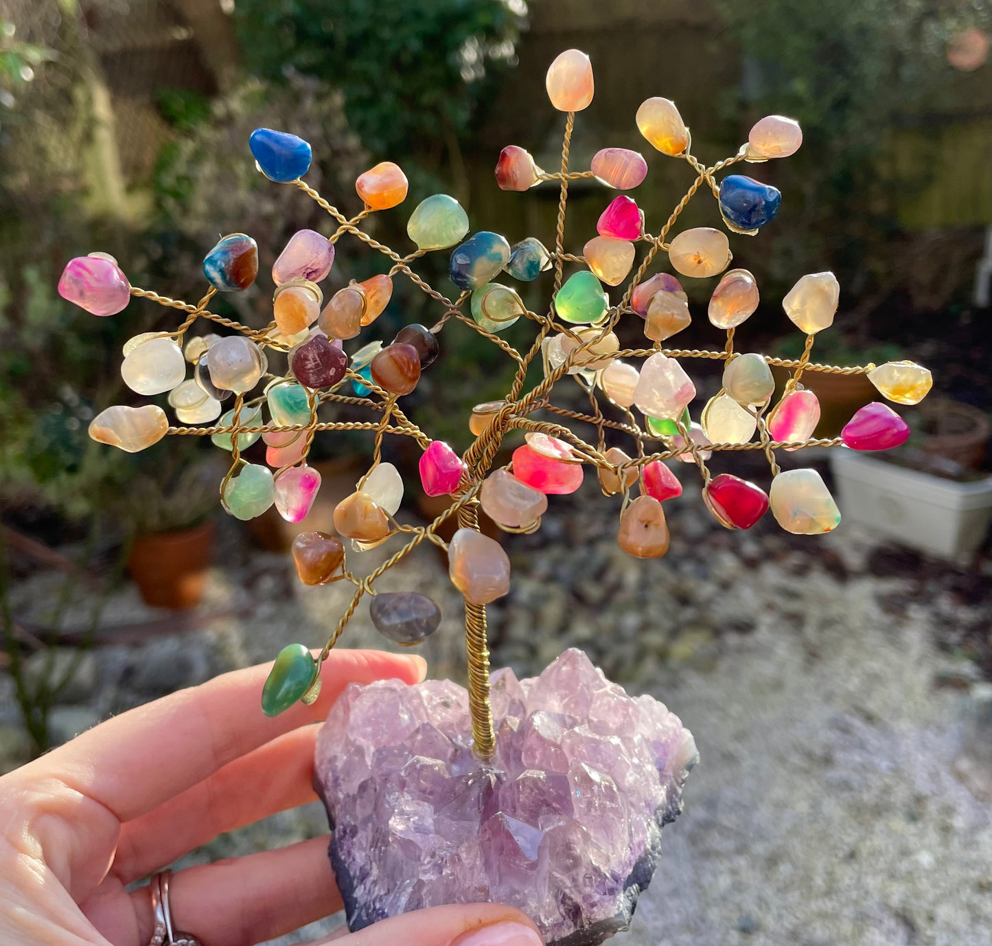 Multi coloured tumble stone crystal tree with amethyst rough base