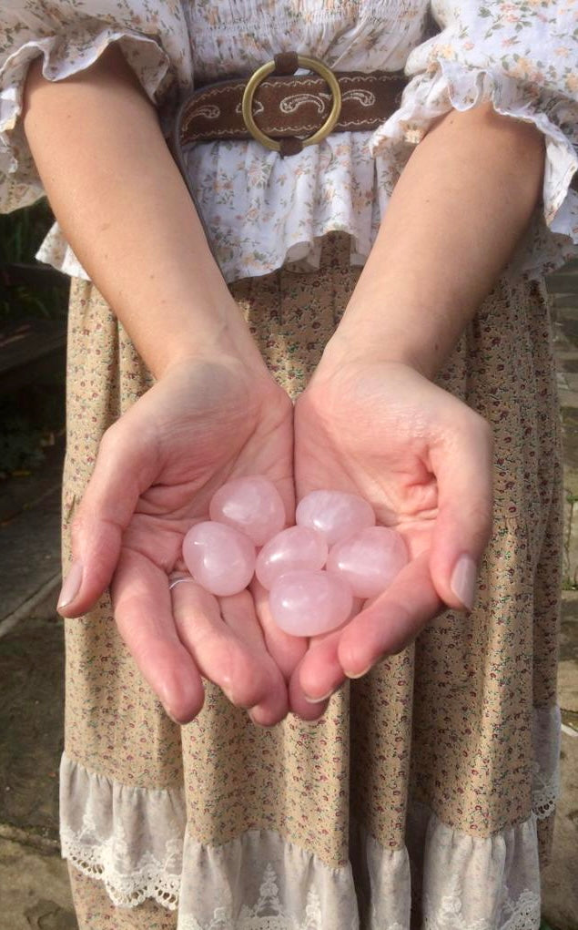 Rose quartz love puff hearts held in two hands